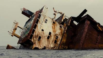 A rusty capsized ship